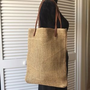 Cute straw bag with cotton lining. Brown handles.